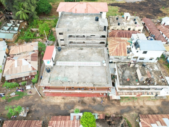 Apartment block for sale in Majengo Malindi with 10 units generating KES 110,000 monthly income, expandable structure and road frontage.
