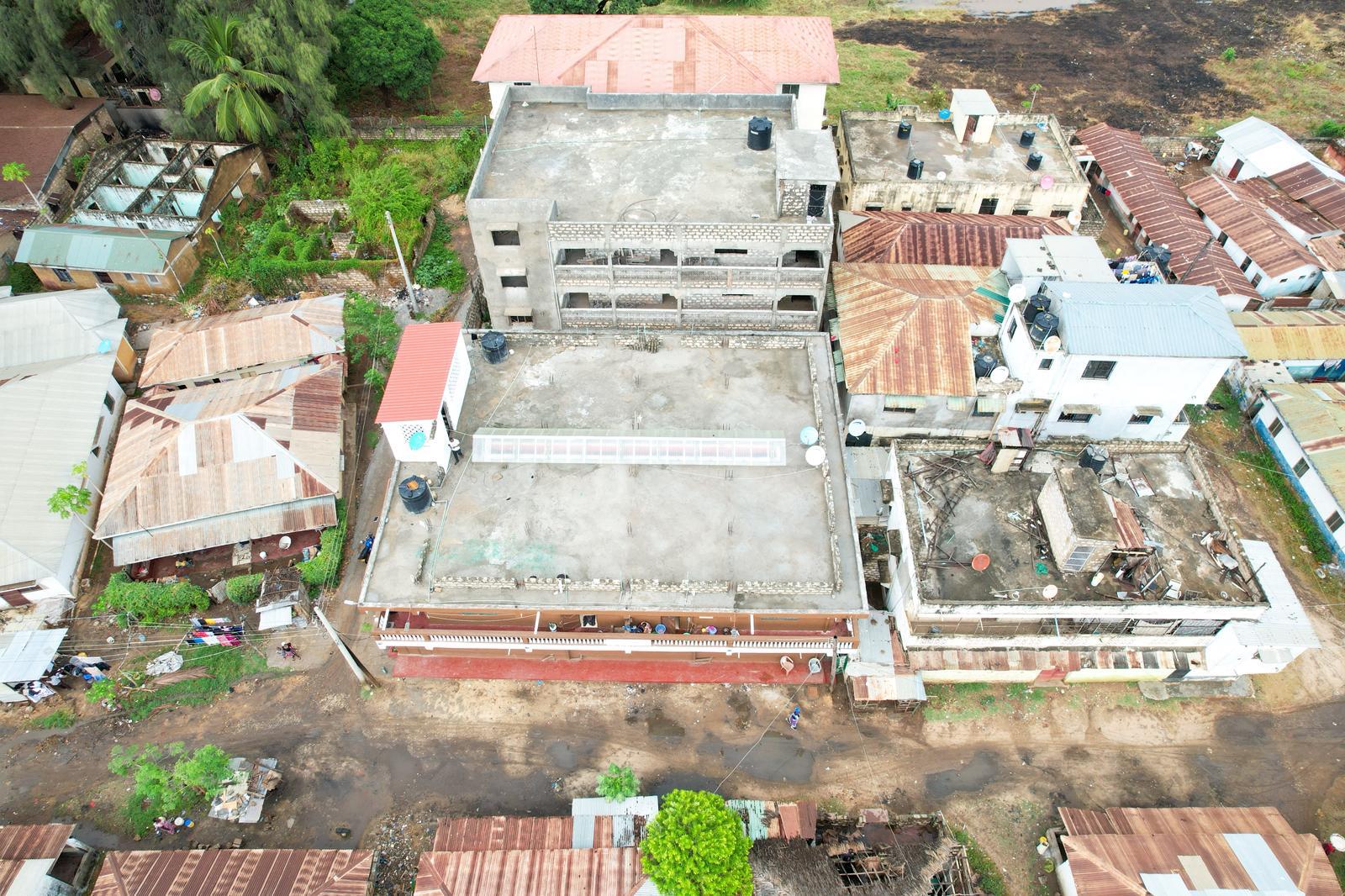 Apartment block for sale in Majengo Malindi with 10 units generating KES 110,000 monthly income, expandable structure and road frontage.