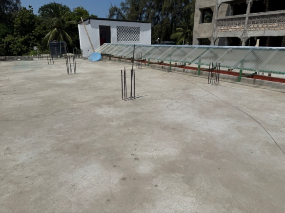 Apartment block for sale in Majengo Malindi with 10 units generating KES 110,000 monthly income, expandable structure and road frontage.
