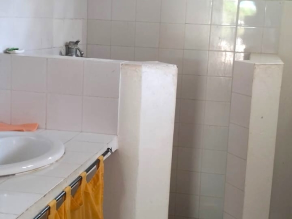 3-bedroom coastal home on 1-acre titled plot in Che Shale with solar panels, rainwater harvesting, balcony, and verandah. Expansion potential on adjoining 3/4-acre land.