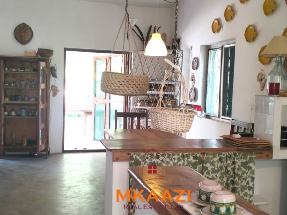 3-bedroom coastal home on 1-acre titled plot in Che Shale with solar panels, rainwater harvesting, balcony, and verandah. Expansion potential on adjoining 3/4-acre land.