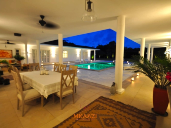 Luxury 4-bedroom villa for sale in Malindi near Casuarina Road with pool, landscaped gardens, staff quarters, and high-end finishes on 1.25 acres.