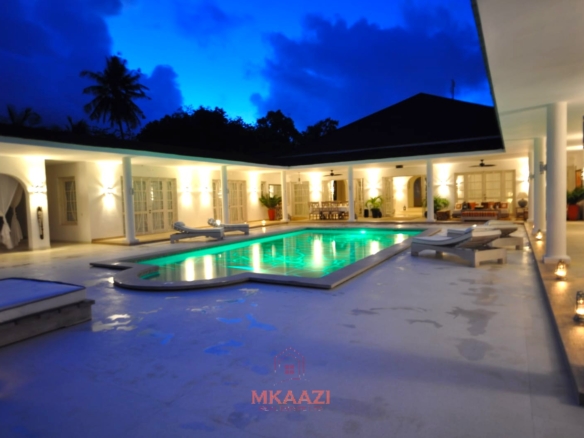 Luxury 4-bedroom villa for sale in Malindi near Casuarina Road with pool, landscaped gardens, staff quarters, and high-end finishes on 1.25 acres.