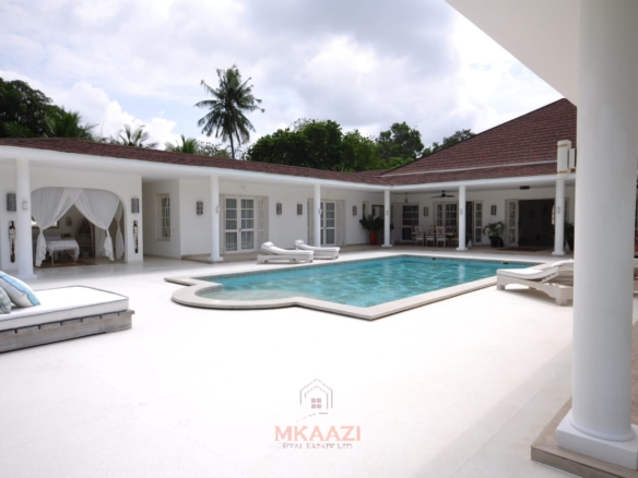 Luxury 4-bedroom villa for sale in Malindi near Casuarina Road with pool, landscaped gardens, staff quarters, and high-end finishes on 1.25 acres.