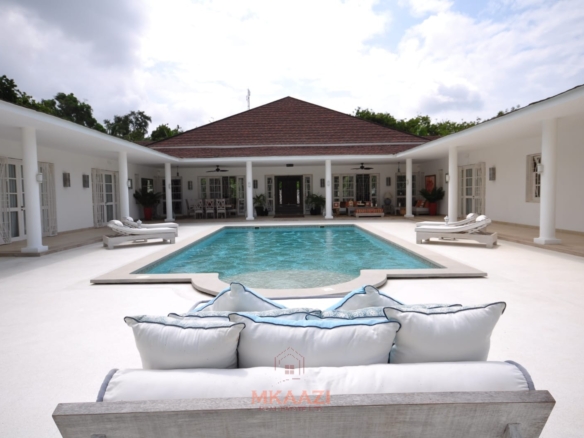 Luxury 4-bedroom villa for sale in Malindi near Casuarina Road with pool, landscaped gardens, staff quarters, and high-end finishes on 1.25 acres.