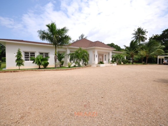 Luxury 4-bedroom villa for sale in Malindi near Casuarina Road with pool, landscaped gardens, staff quarters, and high-end finishes on 1.25 acres.