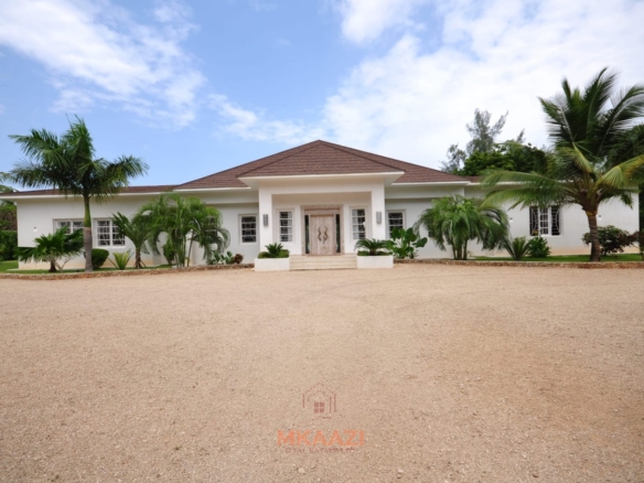 Luxury 4-bedroom villa for sale in Malindi near Casuarina Road with pool, landscaped gardens, staff quarters, and high-end finishes on 1.25 acres.