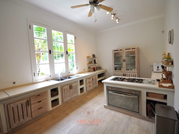 Luxury 4-bedroom villa for sale in Malindi near Casuarina Road with pool, landscaped gardens, staff quarters, and high-end finishes on 1.25 acres.