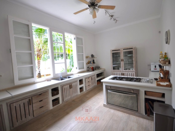 Luxury 4-bedroom villa for sale in Malindi near Casuarina Road with pool, landscaped gardens, staff quarters, and high-end finishes on 1.25 acres.