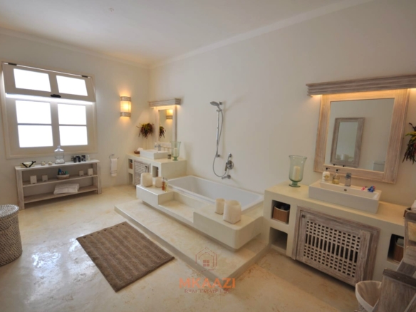 Luxury 4-bedroom villa for sale in Malindi near Casuarina Road with pool, landscaped gardens, staff quarters, and high-end finishes on 1.25 acres.