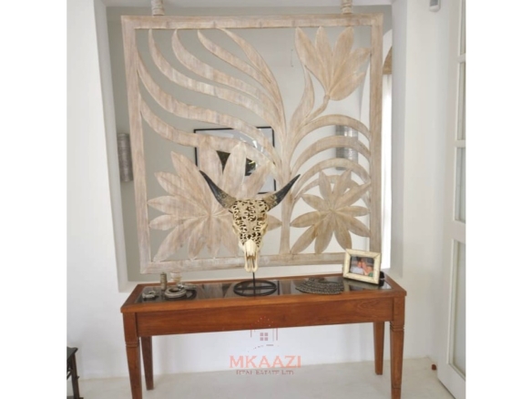 Luxury 4-bedroom villa for sale in Malindi near Casuarina Road with pool, landscaped gardens, staff quarters, and high-end finishes on 1.25 acres.