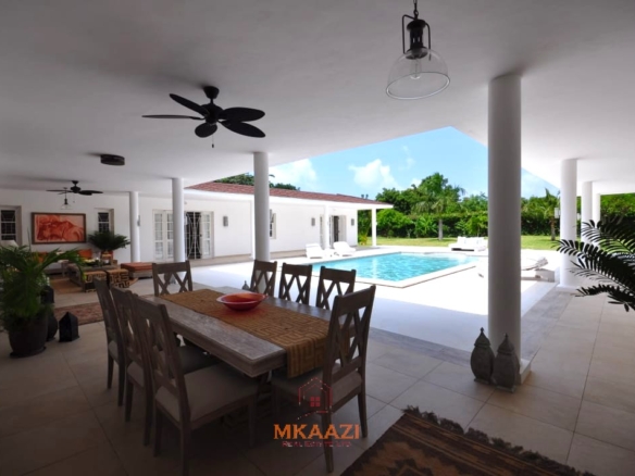 Luxury 4-bedroom villa for sale in Malindi near Casuarina Road with pool, landscaped gardens, staff quarters, and high-end finishes on 1.25 acres.