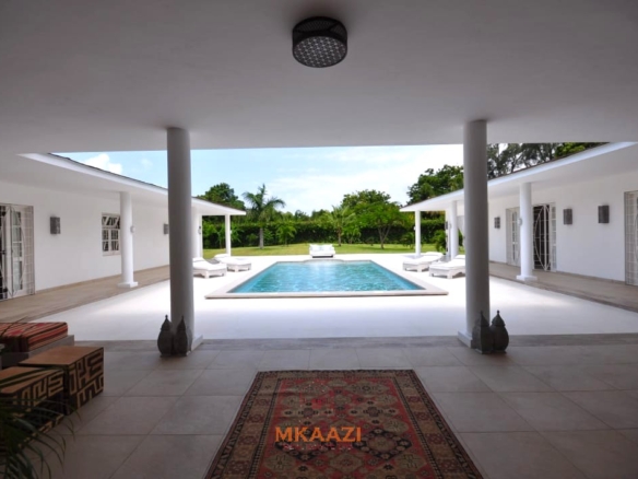 Luxury 4-bedroom villa for sale in Malindi near Casuarina Road with pool, landscaped gardens, staff quarters, and high-end finishes on 1.25 acres.