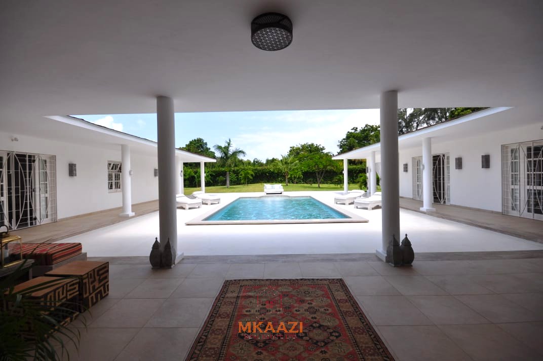 Luxury 4-bedroom villa for sale in Malindi near Casuarina Road with pool, landscaped gardens, staff quarters, and high-end finishes on 1.25 acres.