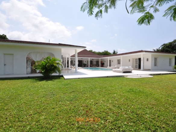 Luxury 4-bedroom villa for sale in Malindi near Casuarina Road with pool, landscaped gardens, staff quarters, and high-end finishes on 1.25 acres.