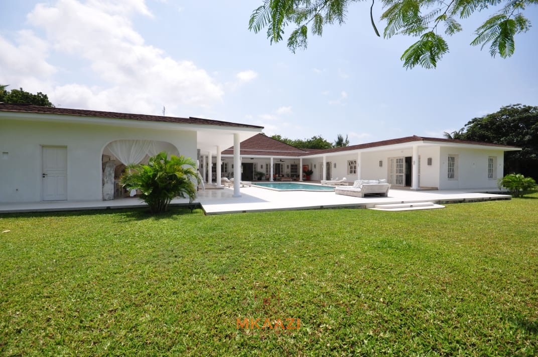 Luxury 4-bedroom villa for sale in Malindi near Casuarina Road with pool, landscaped gardens, staff quarters, and high-end finishes on 1.25 acres.