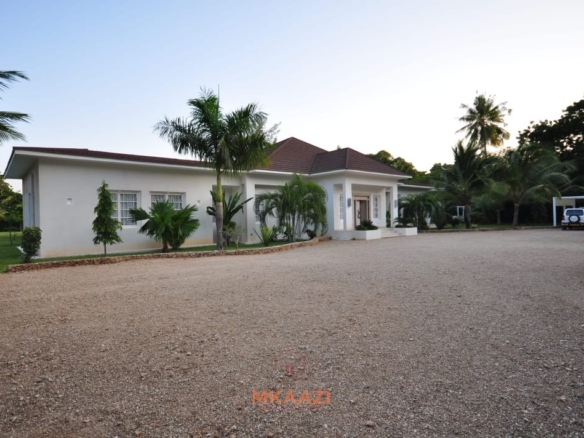Luxury 4-bedroom villa for sale in Malindi near Casuarina Road with pool, landscaped gardens, staff quarters, and high-end finishes on 1.25 acres.