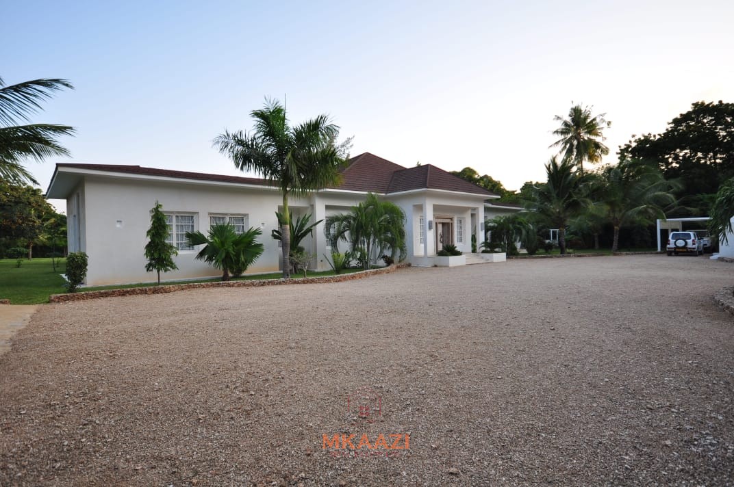 Luxury 4-bedroom villa for sale in Malindi near Casuarina Road with pool, landscaped gardens, staff quarters, and high-end finishes on 1.25 acres.