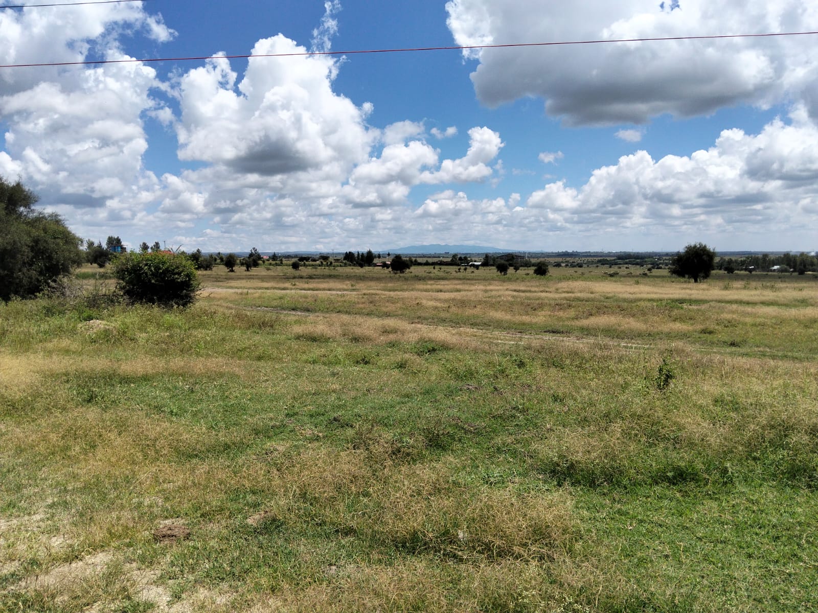Prime 50-acre road frontage land for sale in Kitengela Kisaju ideal for industrial, commercial, residential estate, and mixed-use development with ready title deed.