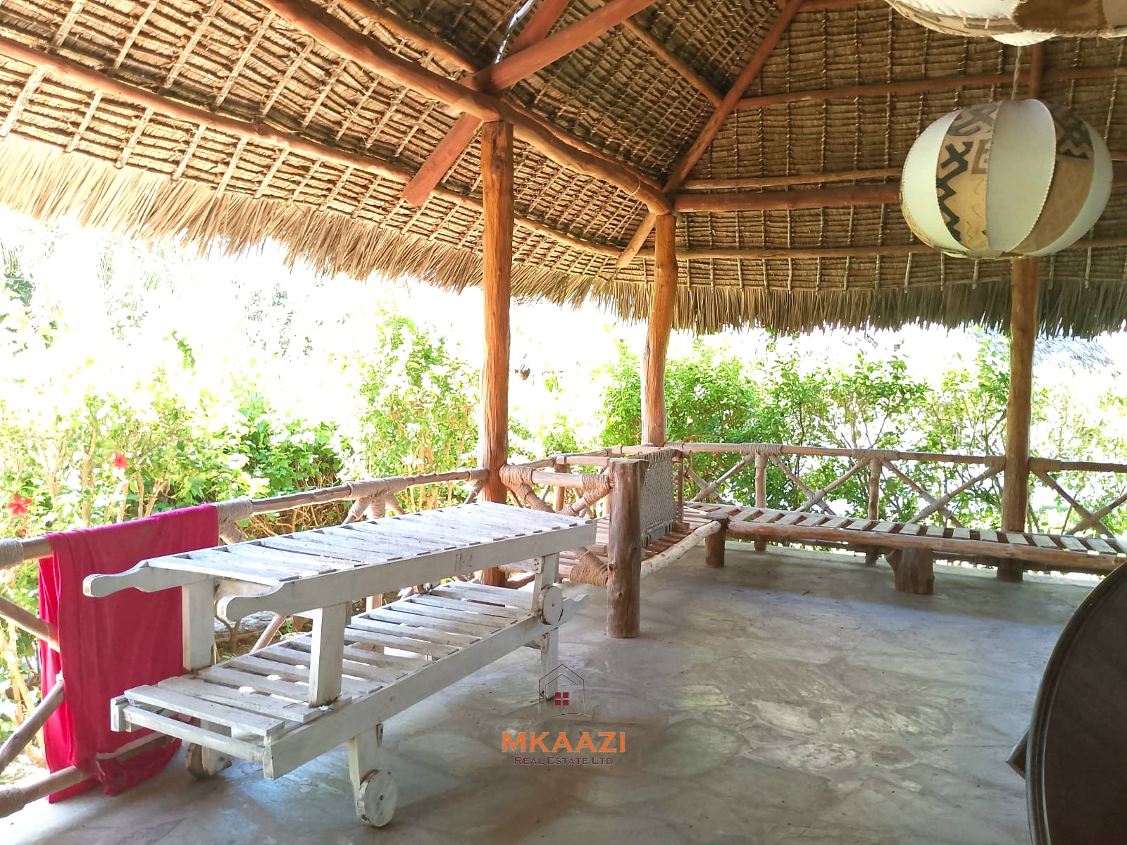 Luxury 4-bedroom en-suite villa for sale near Marine Park Road Malindi with shared pool, private garden, and makuti roof.