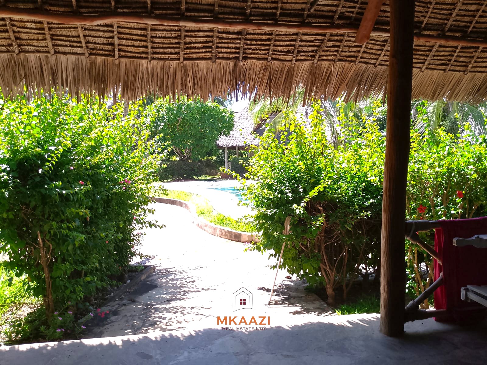 Luxury 4-bedroom en-suite villa for sale near Marine Park Road Malindi with shared pool, private garden, and makuti roof.