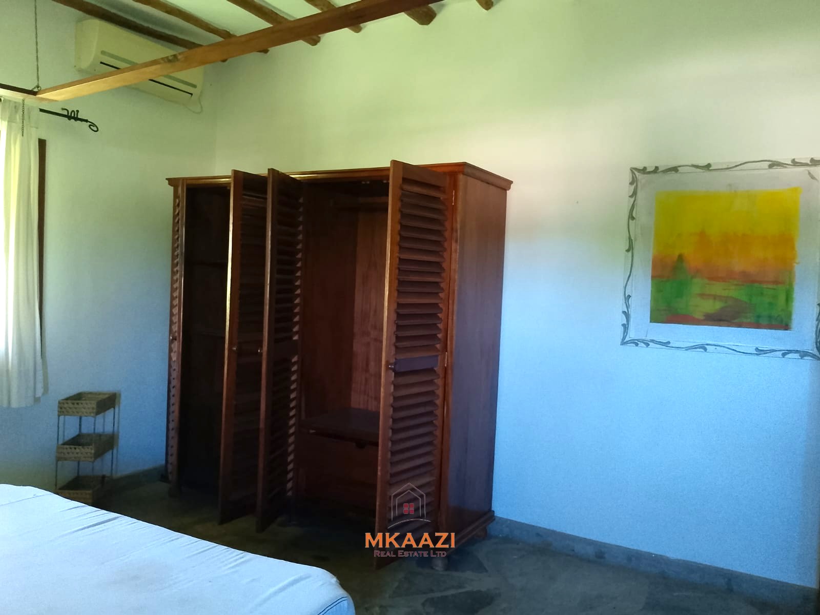 Luxury 4-bedroom en-suite villa for sale near Marine Park Road Malindi with shared pool, private garden, and makuti roof.
