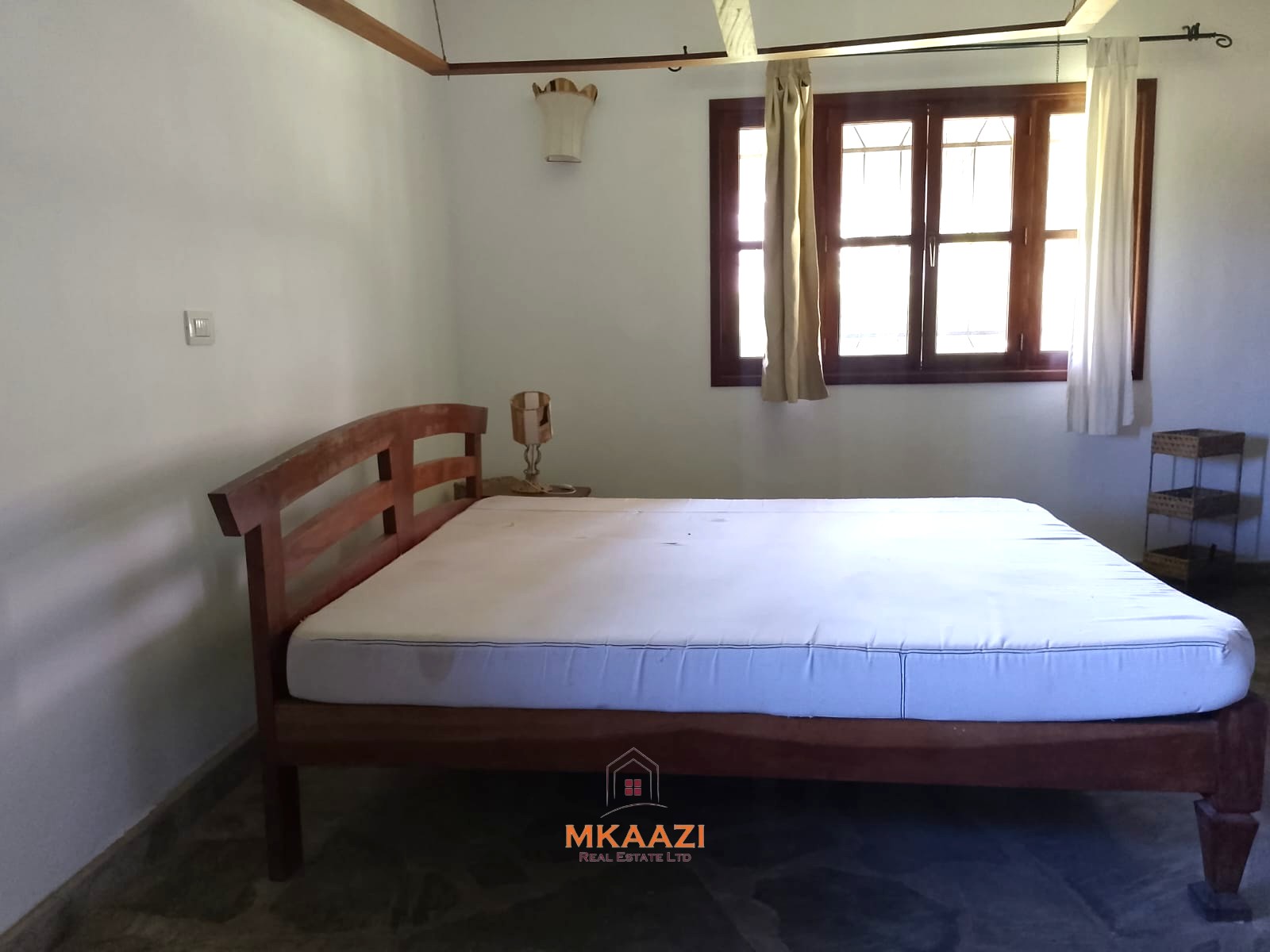 Luxury 4-bedroom en-suite villa for sale near Marine Park Road Malindi with shared pool, private garden, and makuti roof.