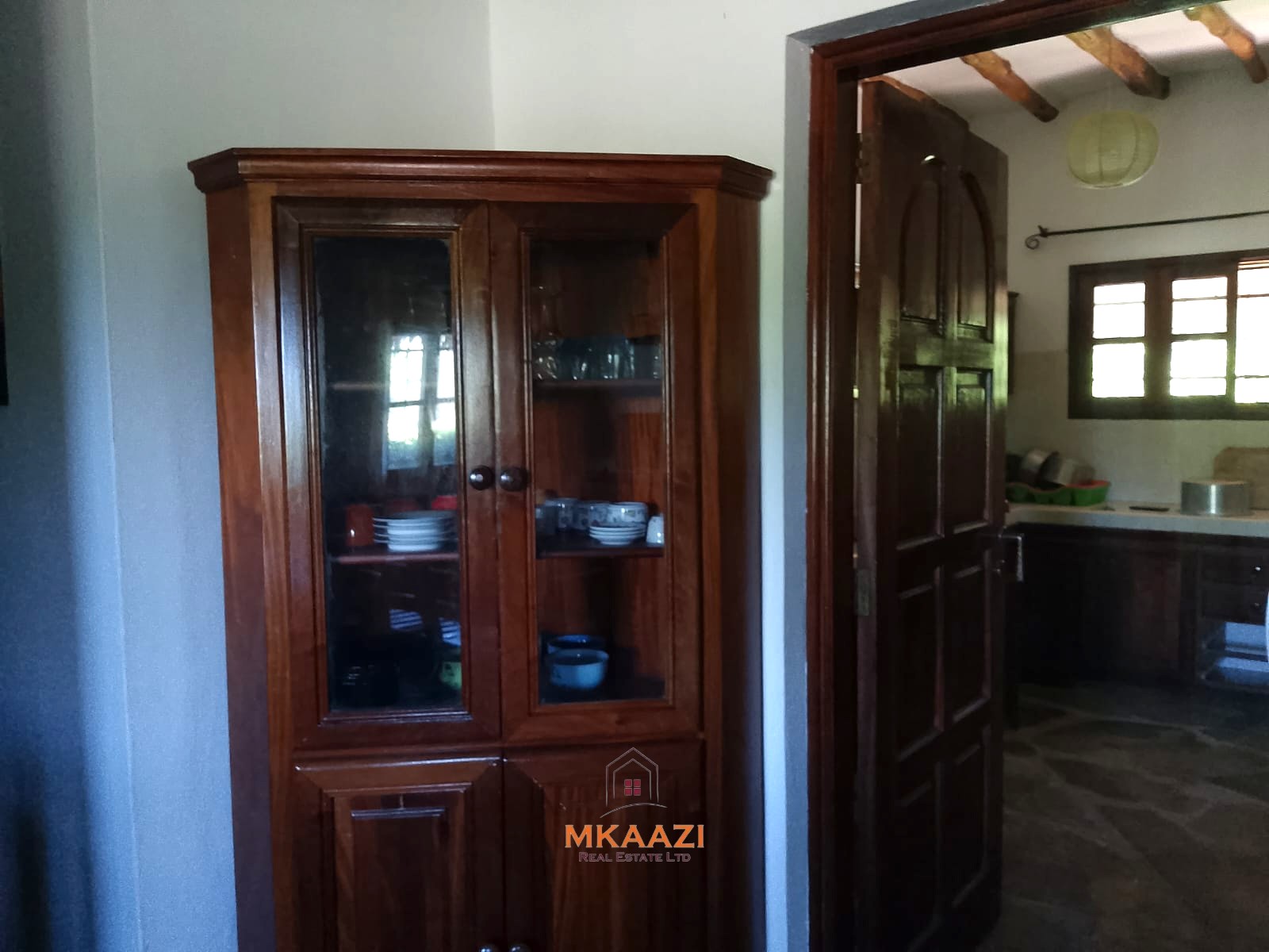 Luxury 4-bedroom en-suite villa for sale near Marine Park Road Malindi with shared pool, private garden, and makuti roof.