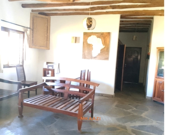 Luxury 4-bedroom en-suite villa for sale near Marine Park Road Malindi with shared pool, private garden, and makuti roof.