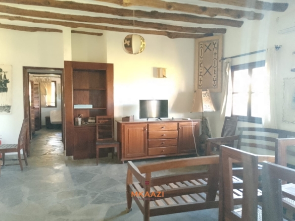 Luxury 4-bedroom en-suite villa for sale near Marine Park Road Malindi with shared pool, private garden, and makuti roof.