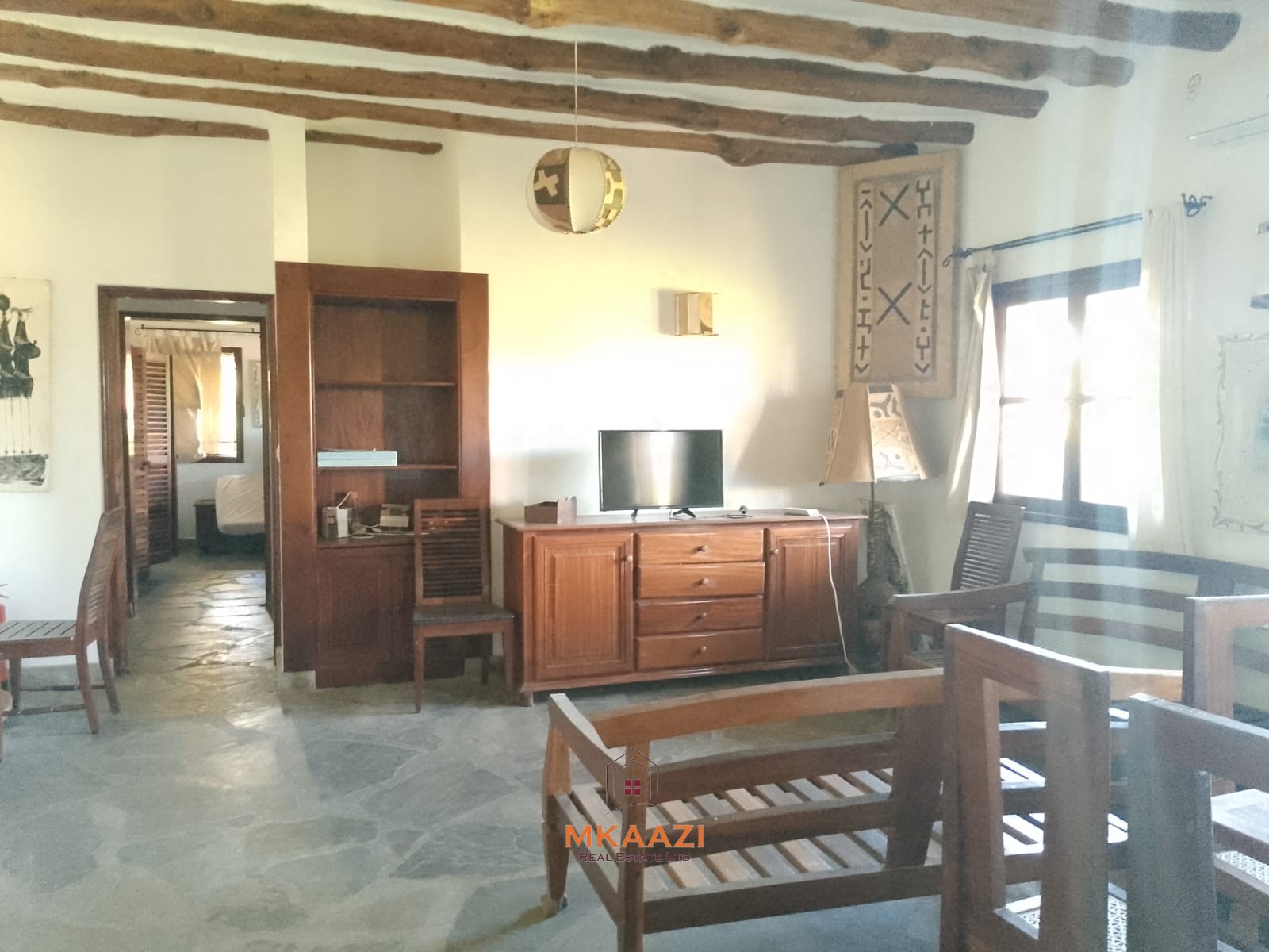 Luxury 4-bedroom en-suite villa for sale near Marine Park Road Malindi with shared pool, private garden, and makuti roof.