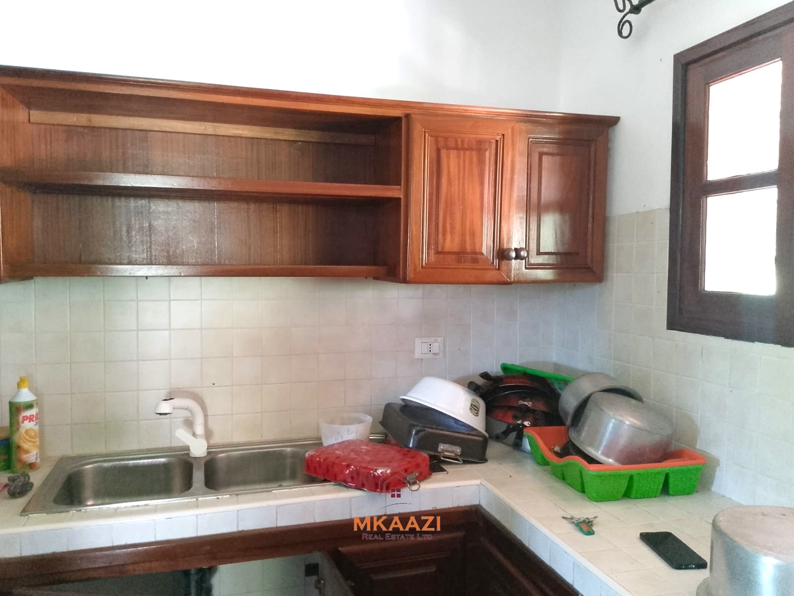 Luxury 4-bedroom en-suite villa for sale near Marine Park Road Malindi with shared pool, private garden, and makuti roof.