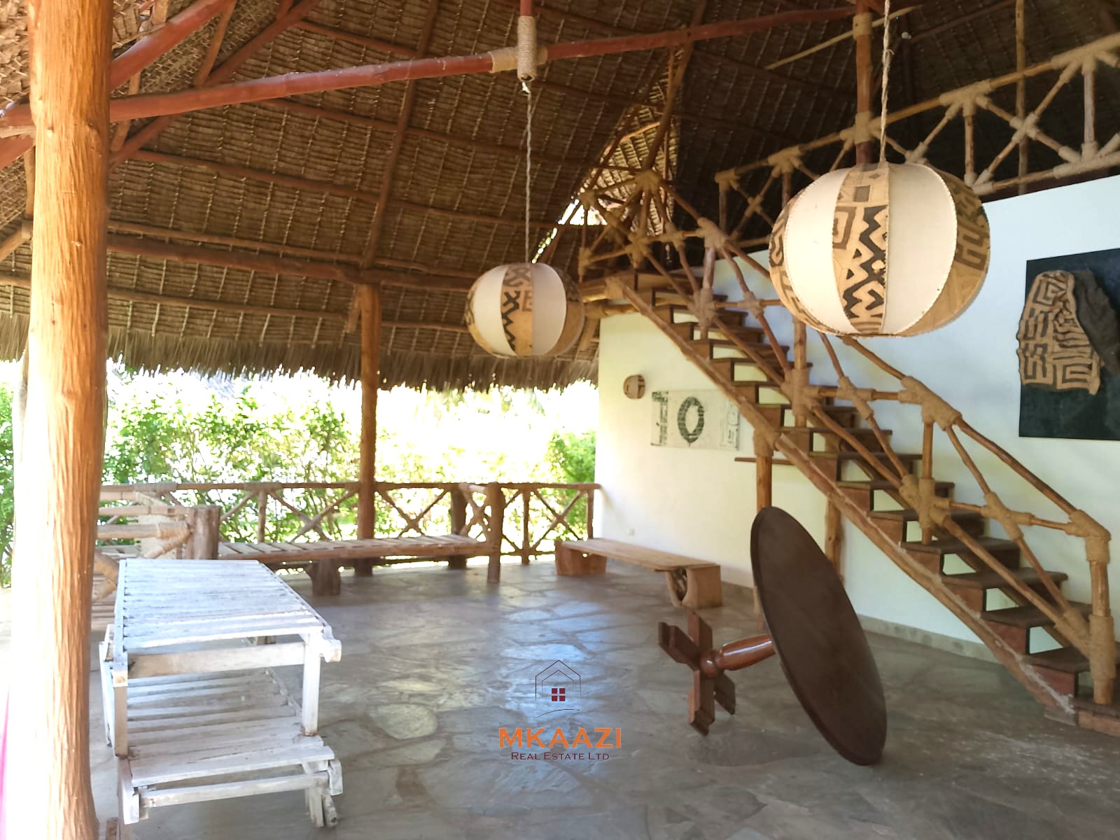 Luxury 4-bedroom en-suite villa for sale near Marine Park Road Malindi with shared pool, private garden, and makuti roof.