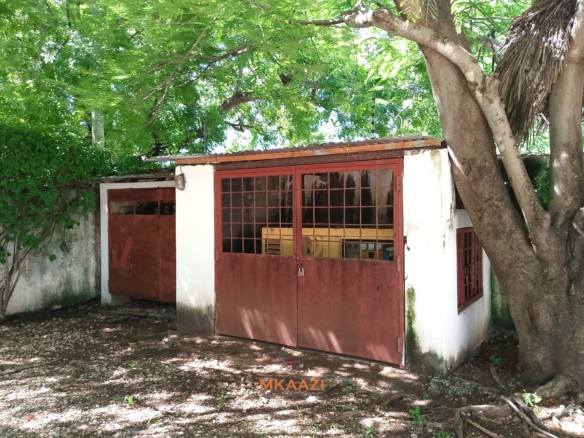 Luxury 4-bedroom en-suite villa for sale near Marine Park Road Malindi with shared pool, private garden, and makuti roof.