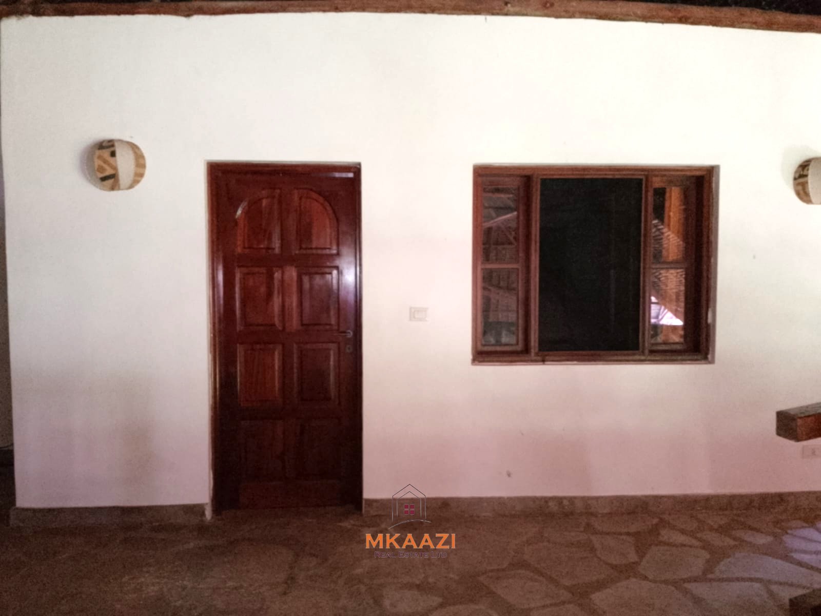 Luxury 4-bedroom en-suite villa for sale near Marine Park Road Malindi with shared pool, private garden, and makuti roof.