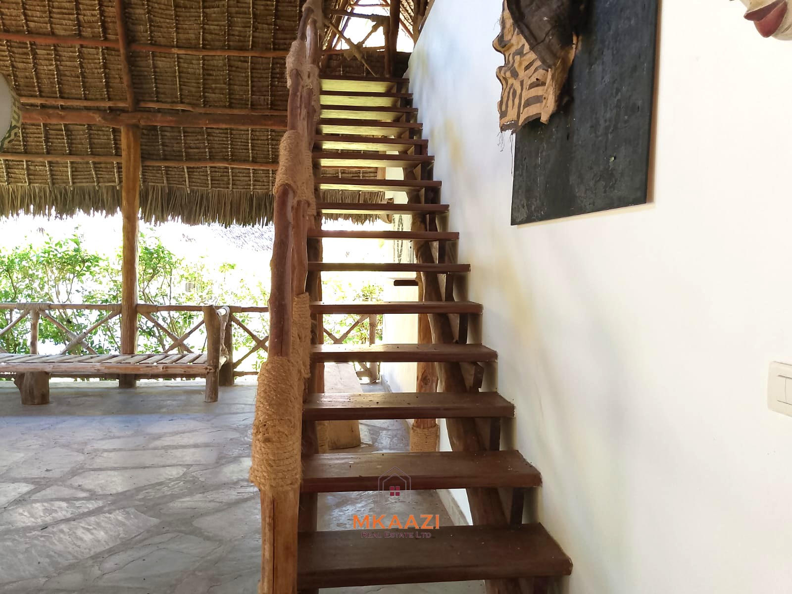 Luxury 4-bedroom en-suite villa for sale near Marine Park Road Malindi with shared pool, private garden, and makuti roof.