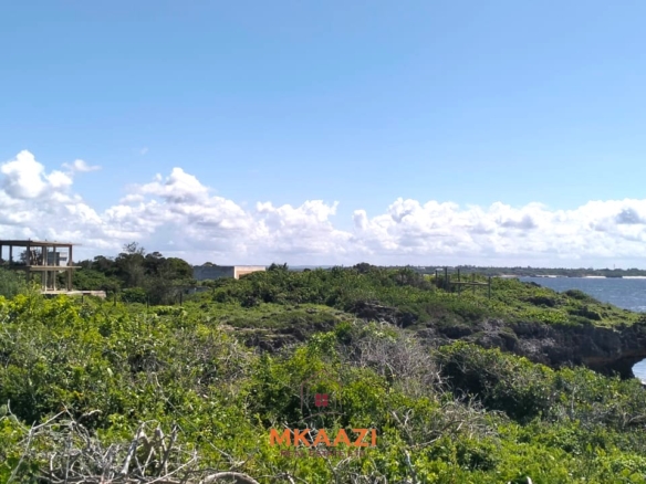 3-acre cliffside beachfront land for sale in Uyombo with sandy beach access and panoramic Indian Ocean views.