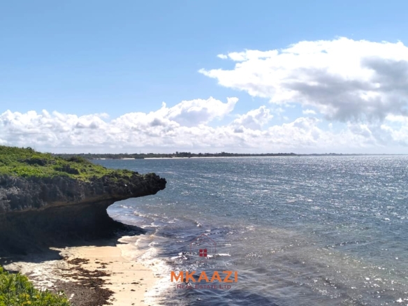 3-acre cliffside beachfront land for sale in Uyombo with sandy beach access and panoramic Indian Ocean views.