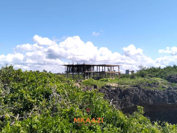 3-acre cliffside beachfront land for sale in Uyombo with sandy beach access and panoramic Indian Ocean views.