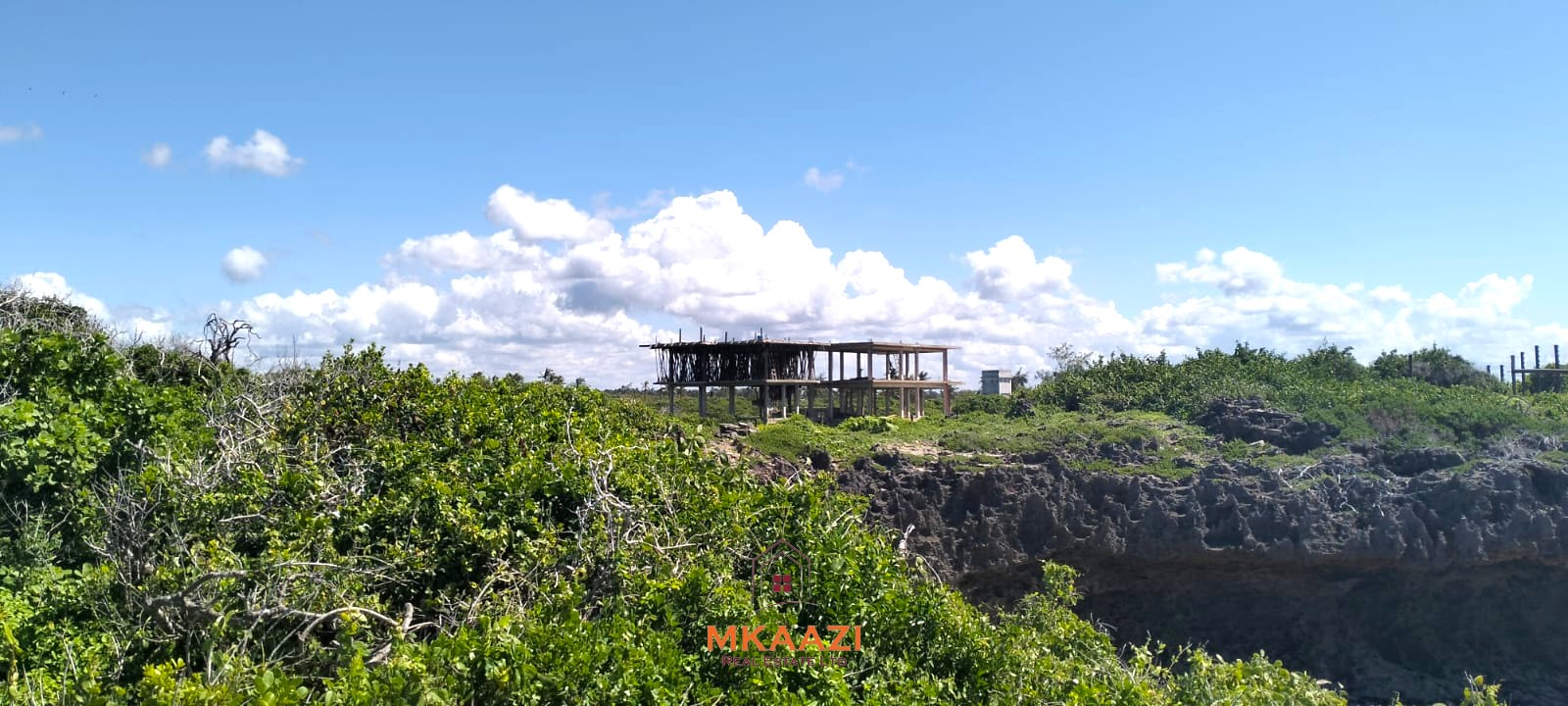 3-acre cliffside beachfront land for sale in Uyombo with sandy beach access and panoramic Indian Ocean views.
