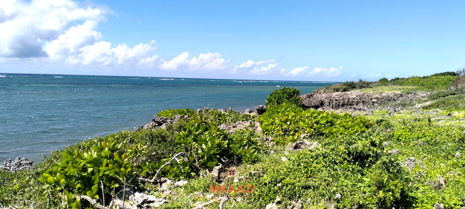 3-acre cliffside beachfront land for sale in Uyombo with sandy beach access and panoramic Indian Ocean views.