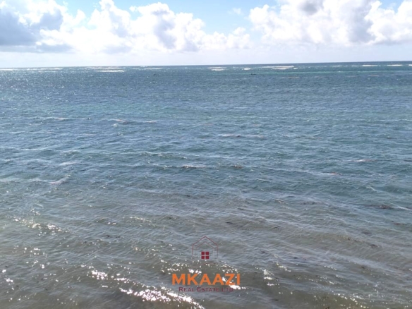 3-acre cliffside beachfront land for sale in Uyombo with sandy beach access and panoramic Indian Ocean views.