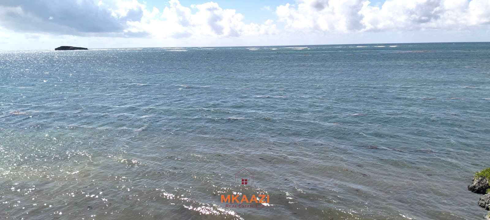 3-acre cliffside beachfront land for sale in Uyombo with sandy beach access and panoramic Indian Ocean views.