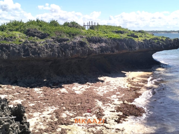 3-acre cliffside beachfront land for sale in Uyombo with sandy beach access and panoramic Indian Ocean views.