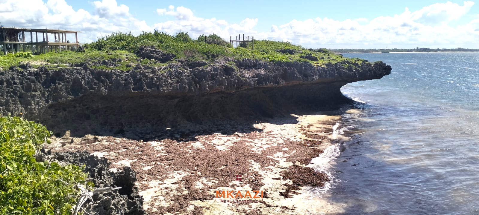3-acre cliffside beachfront land for sale in Uyombo with sandy beach access and panoramic Indian Ocean views.