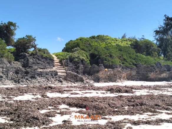 5-acre beachfront land for sale in Uyombo featuring sandy beachfront access, freehold title deed, coral bedrock foundation, and prime investment potential along Kenya’s North Coast.