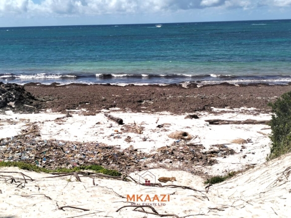 5-acre beachfront land for sale in Uyombo featuring sandy beachfront access, freehold title deed, coral bedrock foundation, and prime investment potential along Kenya’s North Coast.