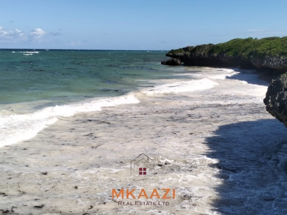 20-acre beachfront land for sale in Chumani featuring sandy beach access, gated and walled boundaries, coral bedrock foundation, and premium investment potential.