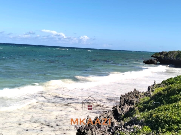 20-acre beachfront land for sale in Chumani featuring sandy beach access, gated and walled boundaries, coral bedrock foundation, and premium investment potential.
