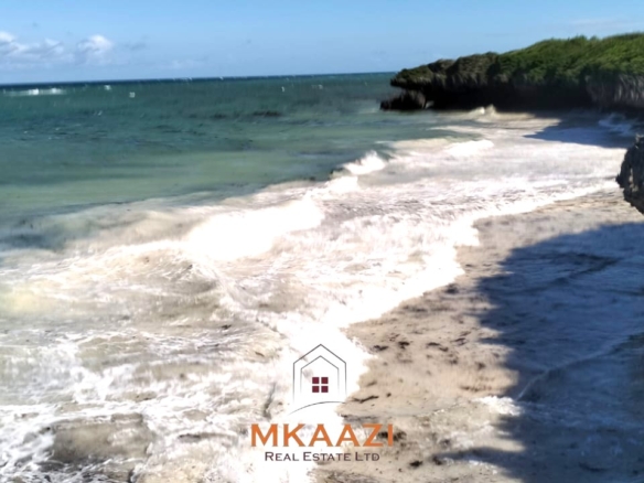20-acre beachfront land for sale in Chumani featuring sandy beach access, gated and walled boundaries, coral bedrock foundation, and premium investment potential.